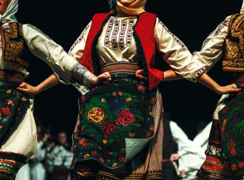 Abstract composition showing three women dressed in Serbian traditional clothe dancing in folklore.